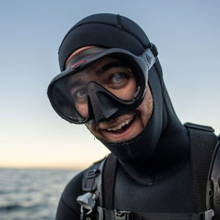 Chris Honeyman wearing dive gear and smiling